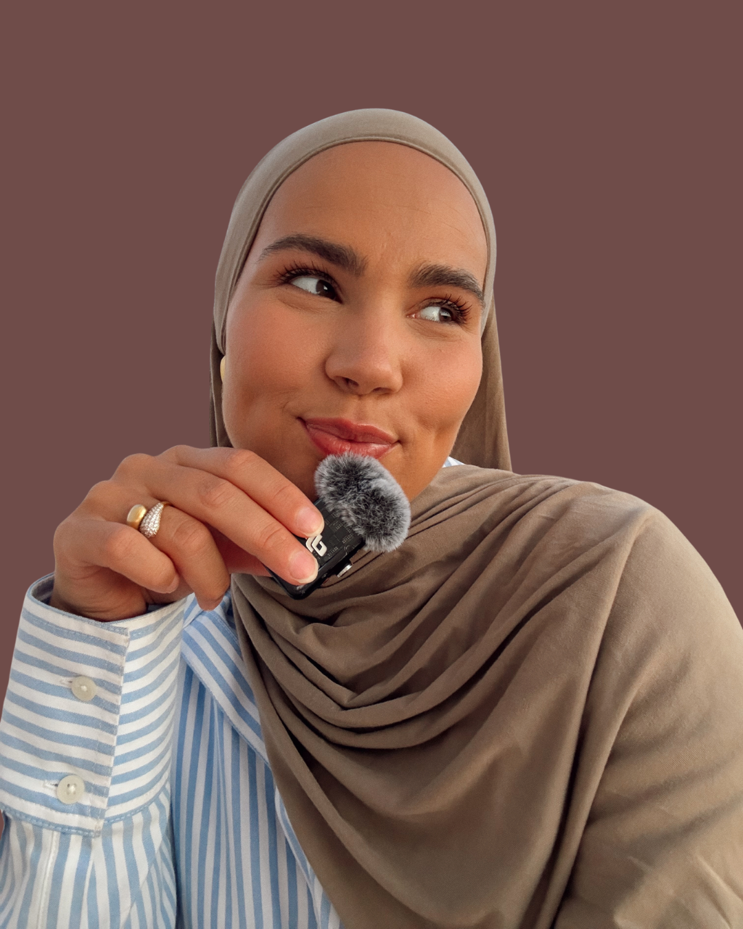 Iman Meskini holding a microphone