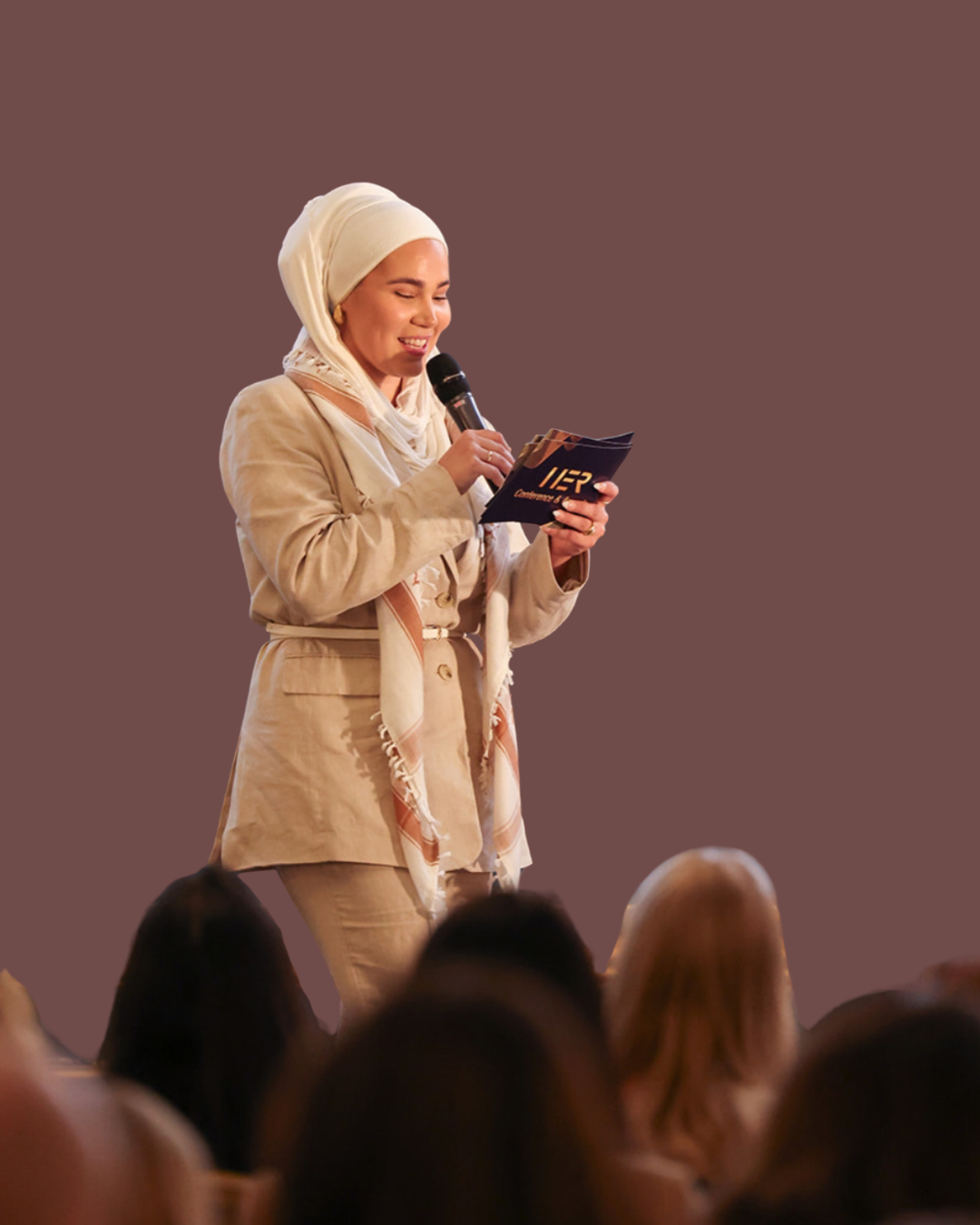 Iman Meskini speaking in front of an audience